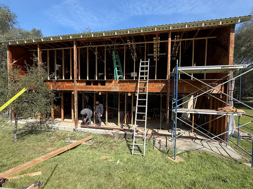 Building exterior opened up during reconstruction, showing exposed framing