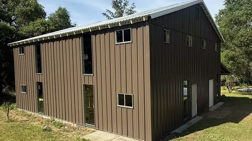 Completed dark metal building exterior after reconstruction